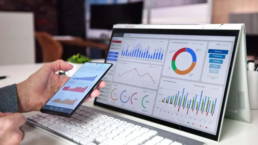 a screen and mobile phone showing analytic data
